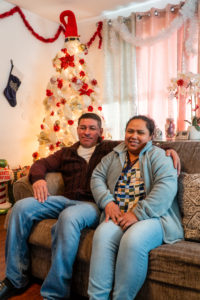 Fredy and Ana Jimenez enjoy the warmth of their new home at Christmastime. Photo by Stephen Ide/ONE Neighborhood Builders