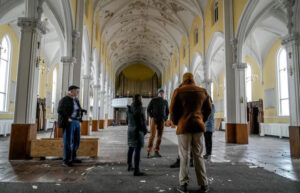 A group tours the former St. Patrick Church in Cumberland, which closed in 2018. Photo by David DelPoio/The Providence Journal