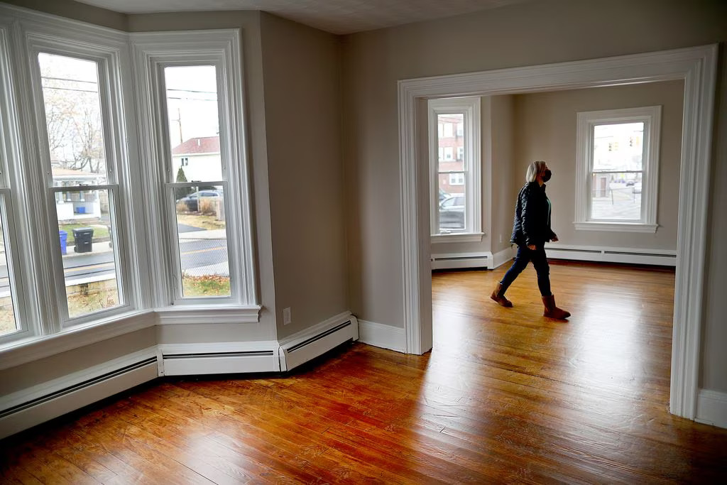 Lisa Guillette, the president of Foster Forward, walks through an apartment building her nonprofit purchased to build affordable housing for young people aging out of the foster care system.JOHN TLUMACKI/GLOBE STAFF