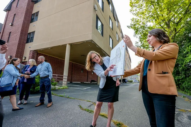 ONE|NB Executive Director Jennifer Hawkins and ONE|NB Chief of Staff Grace Evans, display plans for the Taunton Avenue development. David DelPoio/The Providence Journal